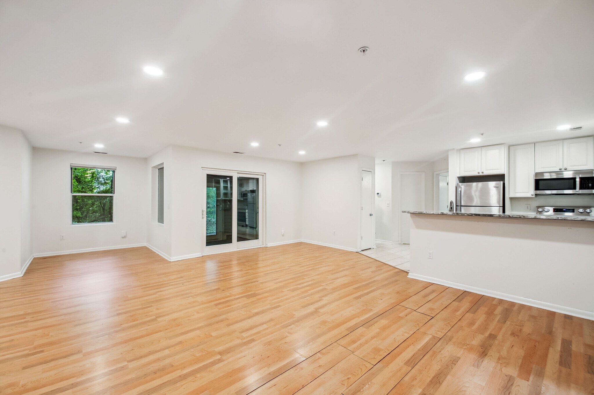 Living Room Looking Into Kitchen on Right and Sliders in Front - 30 Hearthstone Ct