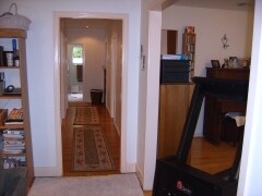 8. LVRM- Looking down hallway to bathroom window to back yard. DNRM right with Kitchen entrance on - 680 Highland St