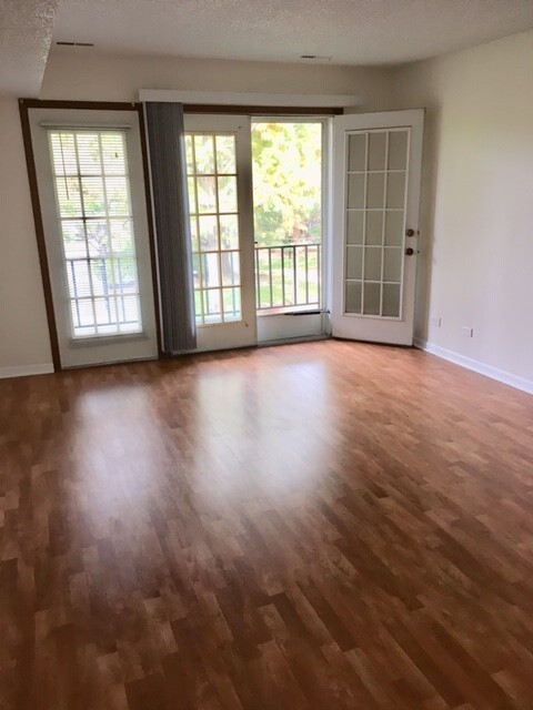 Living room with French doors to the balcony - 520 Biesterfield Rd