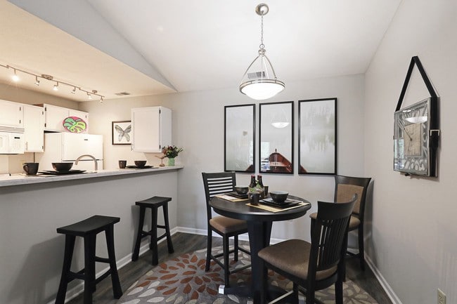 Bright dining area with open kitchen layout—perfect for everyday meals or entertaining guests. - Compass Pointe Apartments