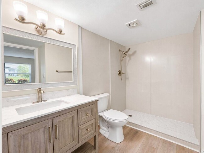 Building Photo - AVAILABLE NOW! Beautifully Renovated First-Floor Condo with Peaceful Screened Lanai