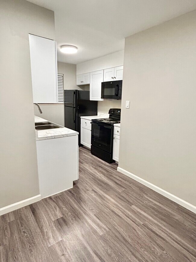 Experience the elegance of this contemporary kitchen, designed with modern functionality in mind. - GRACE LANDINGS APARTMENTS