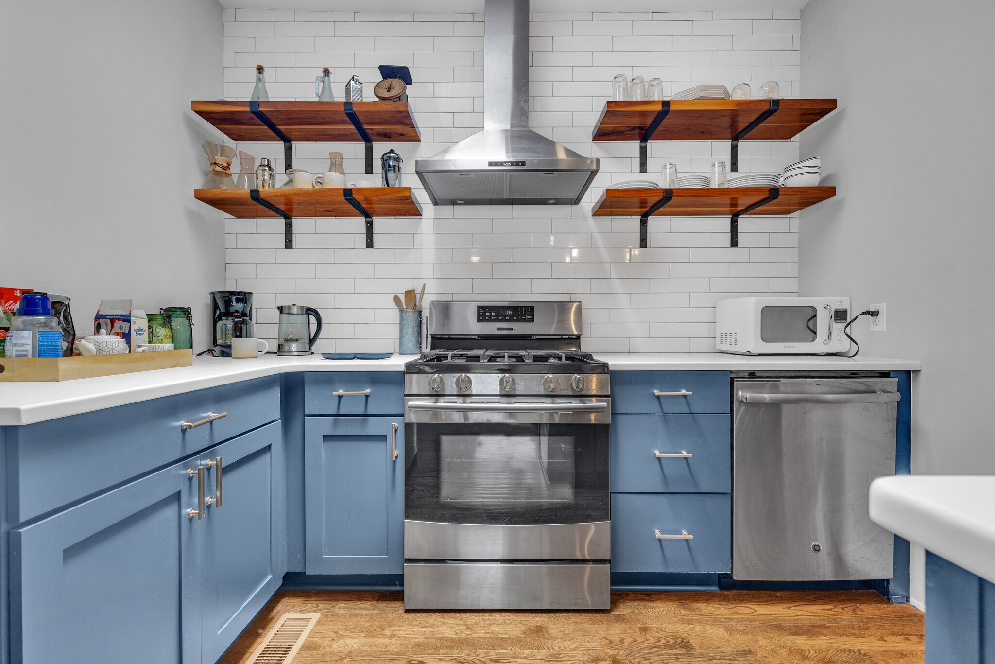 The kitchen is fully equipped with all new stainless steel appliances including a large fridge, stov - 1876 DeKalb Ave NE