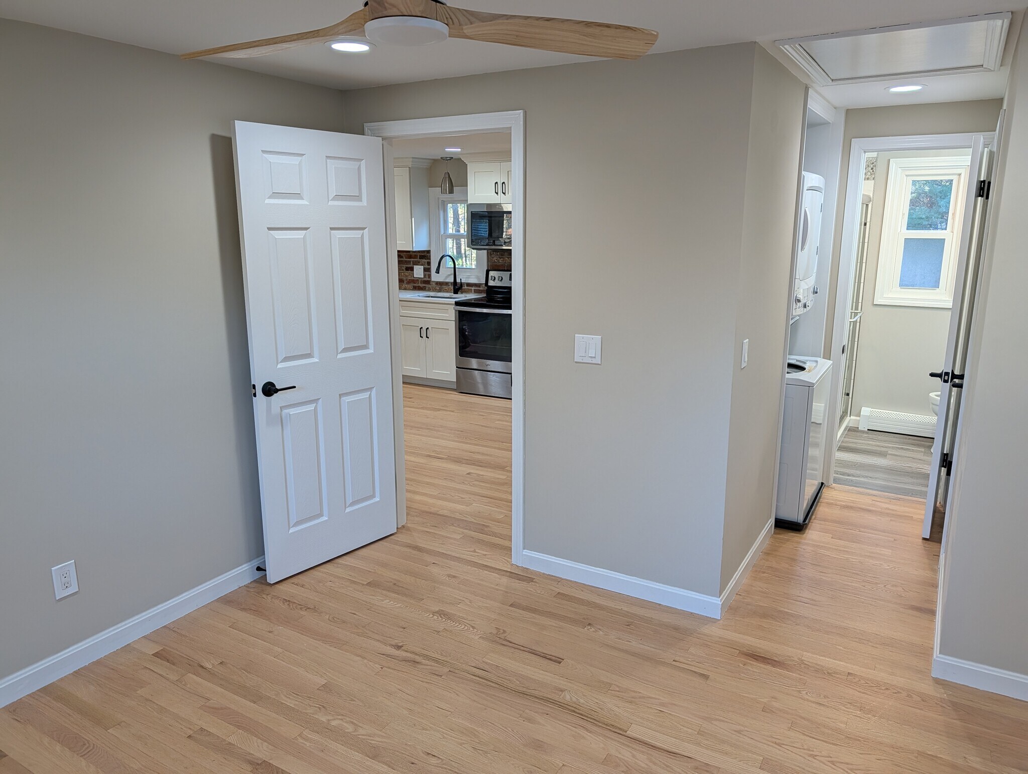 View from bedroom towards kitchen, W/D and bathroom on right - 63 Buttles Rd