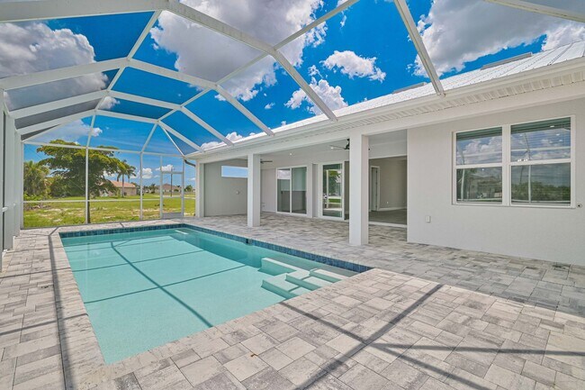 Building Photo - NOW AVAILABLE - Gorgeous Pool Home ~ NW Cape ~ 3 Car Garage ~ On Canal!