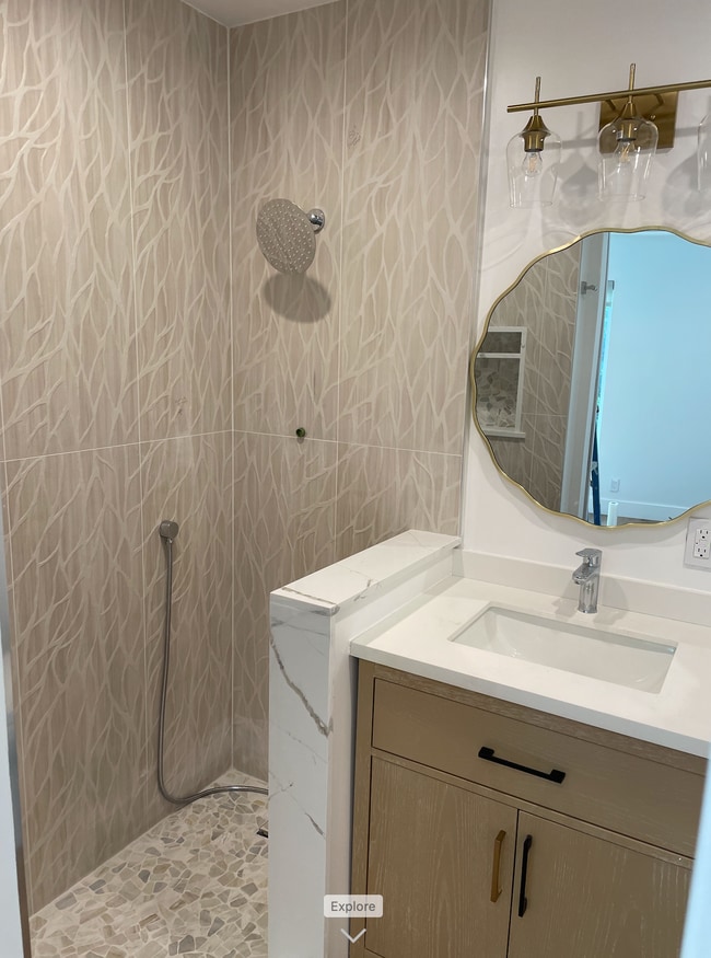 Designer tile with framless shower door and white oak vanity with quartz countertops - 1741 Granville Ave