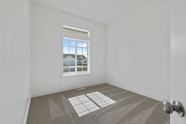 Building Photo - NEW HOME with large garage stalls and unfinished basement for additional storage