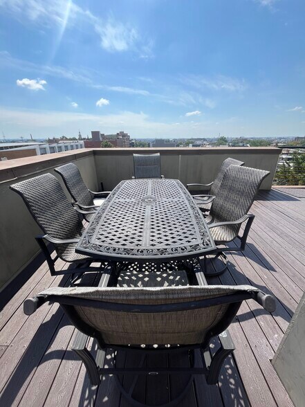 Have friends over for drinks or dinner at the large outdoor dining table. - 2910 Georgia Ave NW