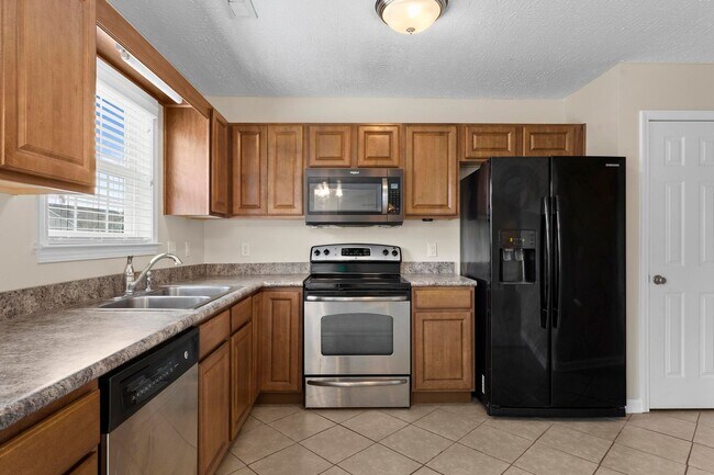 Building Photo - House with Fenced Back Yard Available!