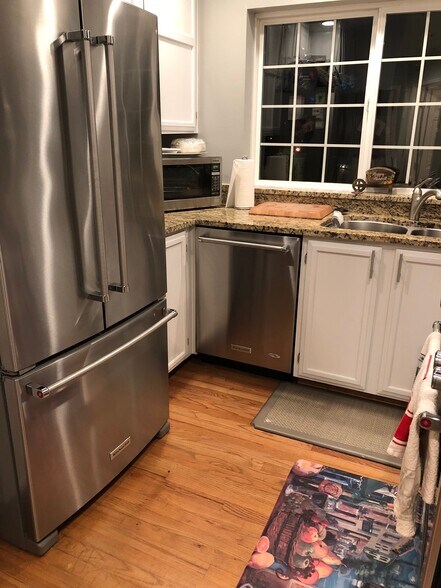 kitchen with new KitchenAid fridge, downdraft oven, dishwasher and new granite counters. - 9915 NE 124th St