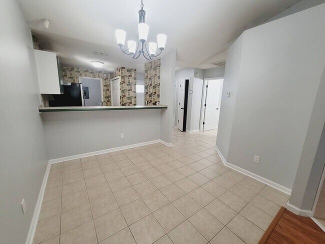 Building Photo - LOVELY 3/2 w/ Screened Porch, New Carpet in Bedrooms, Washer/Dryer, & Privacy Fenced Yard! Includ...