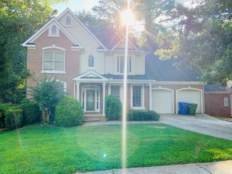 Charming driveway leads to a picturesque walking path and spacious patio, offering a warm French-ins - 2337 Ashmel Ct SW