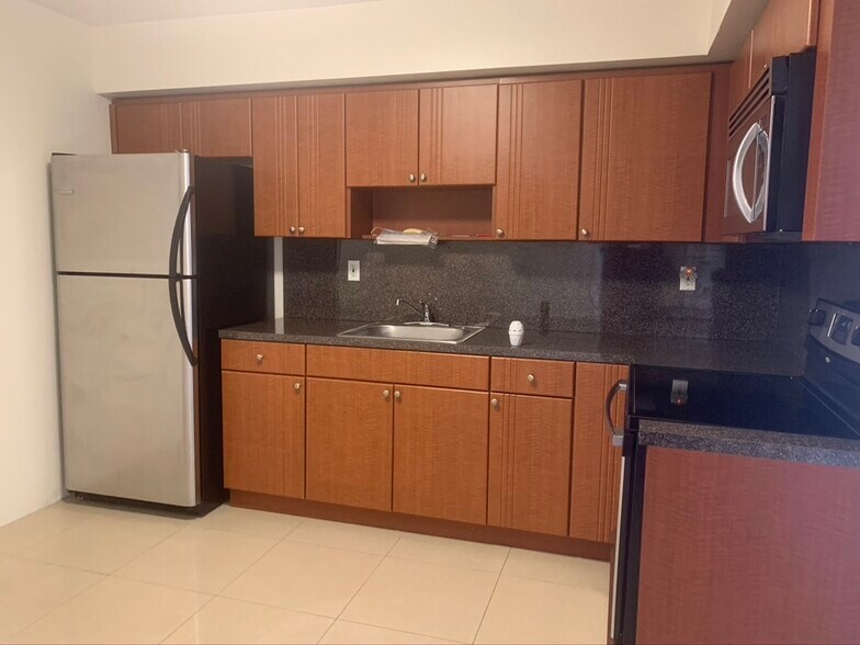 Kitchen with stainless steel appliances - 5010 SW 26th Ave