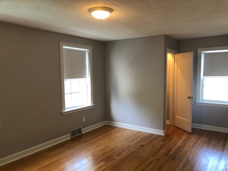 Primary bedroom with plenty of natural light from windows - 6959 Pernod Ave