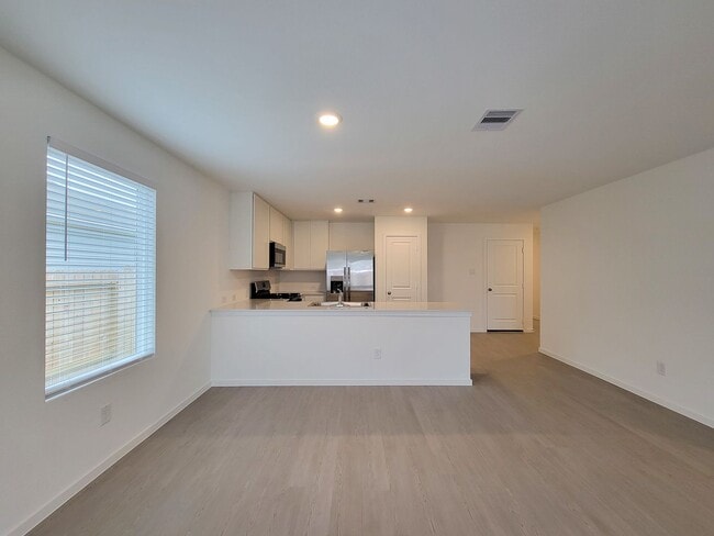 Building Photo - This lovely single-level home showcases a spacious open floorplan shared between the kitchen, din...