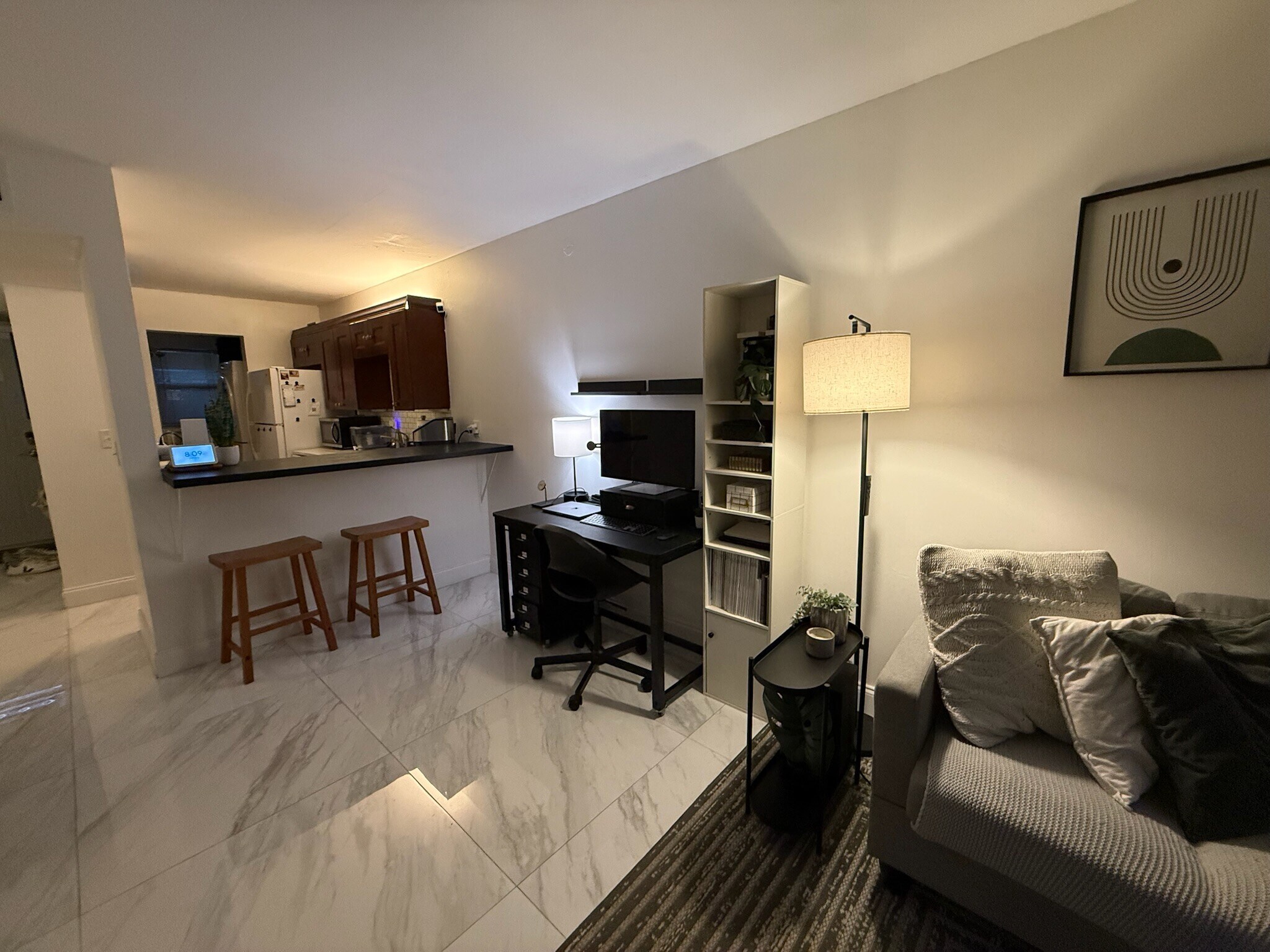 Living area, kitchen, and front door. - 2918 NE 8th Ter