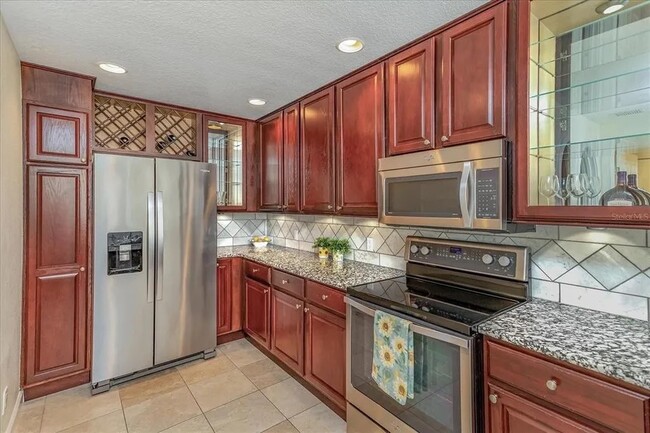 Stainless steel appliances, carrara marbe backsplash, wine cabinet - 8438 Gilford Ln