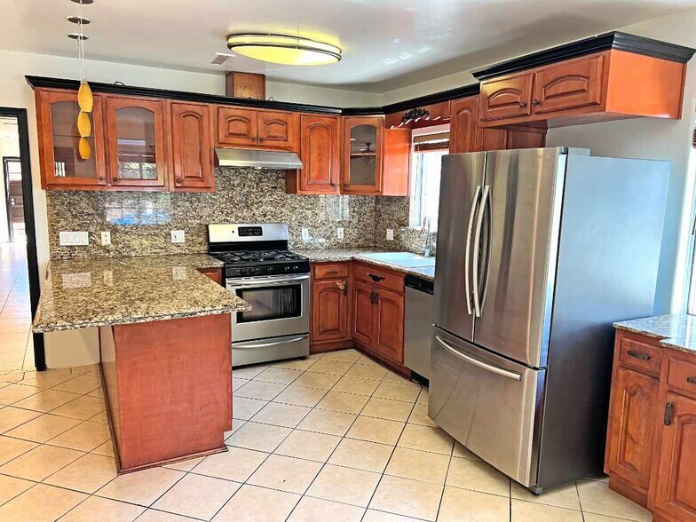 Kitchen from dining area. - 2330 S Mansfield Ave
