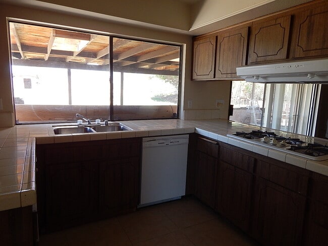 Building Photo - This property is a 3 bedroom, 2 bathroom home featuring an open floor plan with tile throughout. ...