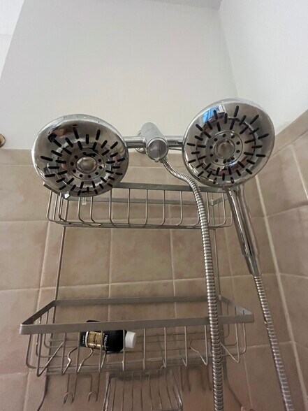 One shower head is detachable and both have multiple settings. - 2910 Georgia Ave NW