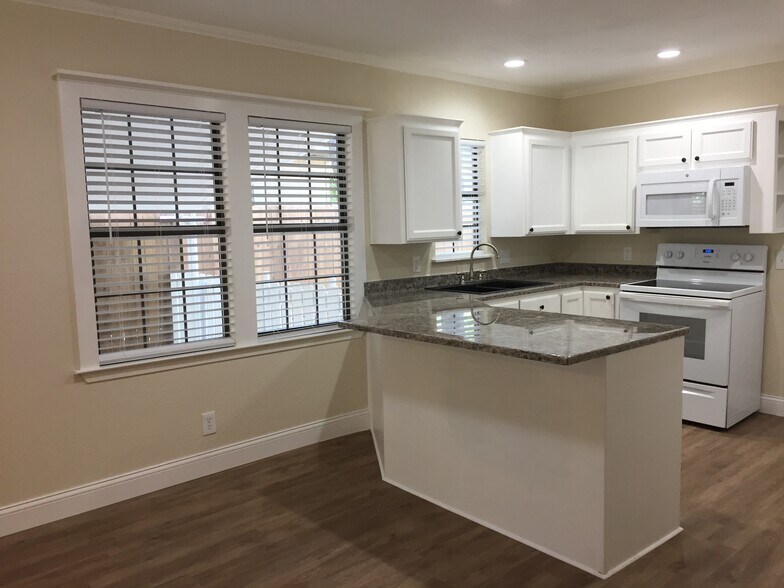 Windows by carport - 310 East 3rd St.