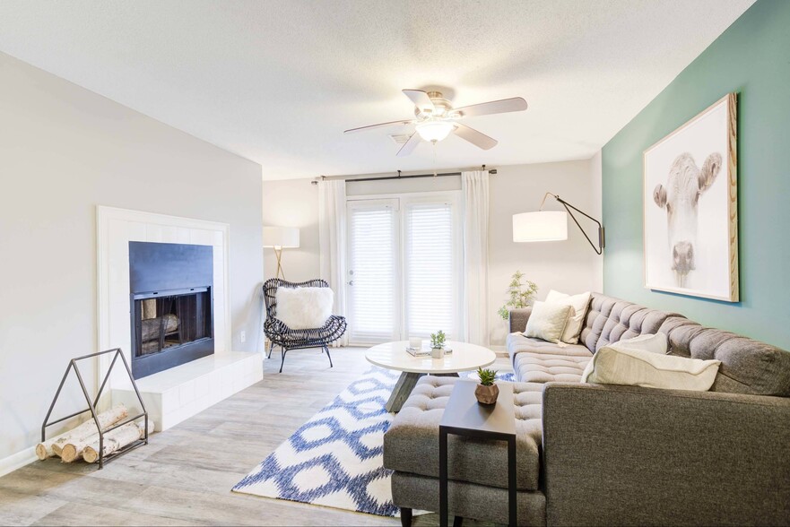 Living area with wood-style flooring and fireplace - Avana Collins Creek