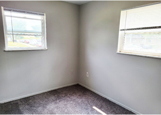 Enjoy the natural light pouring into this cozy corner room, perfect for relaxation. - Beecher Street