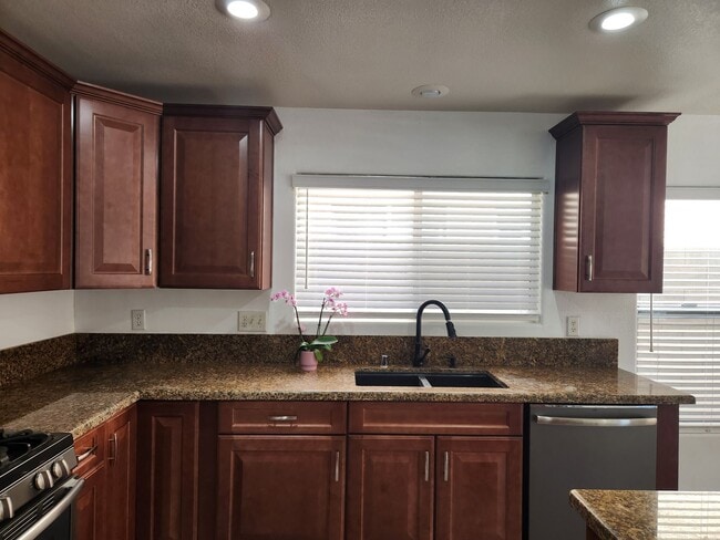 Building Photo - Sleek 2 story home with tile in most living areas and upgraded kitchen.