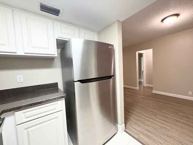 Building Photo - Beautiful Corner Unit with Vinyl Plank Flooring & Private Screened Patio