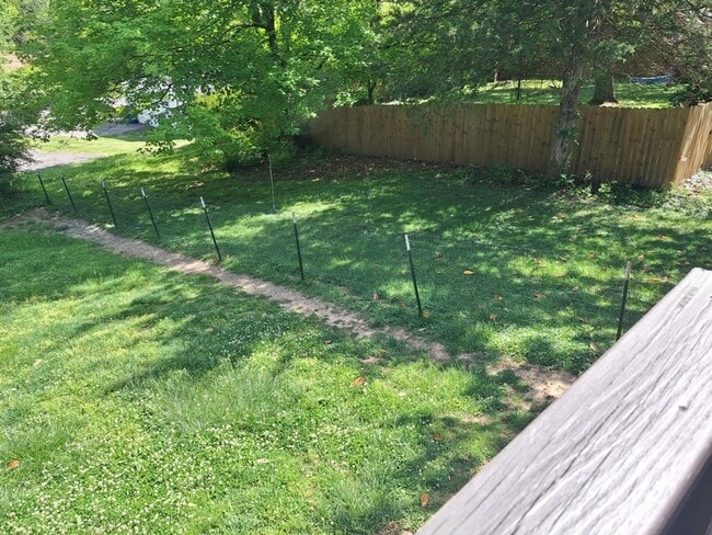 Building Photo - Cute white cottage with white picket fence & Huge deck off back door!