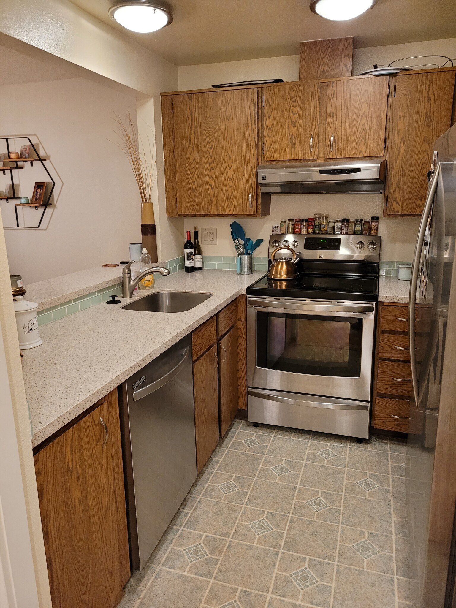 Kitchen with stainless steel oven, dishwasher, fridge, and microwave. Bar looks out into dining room - 15707 4th Ave S