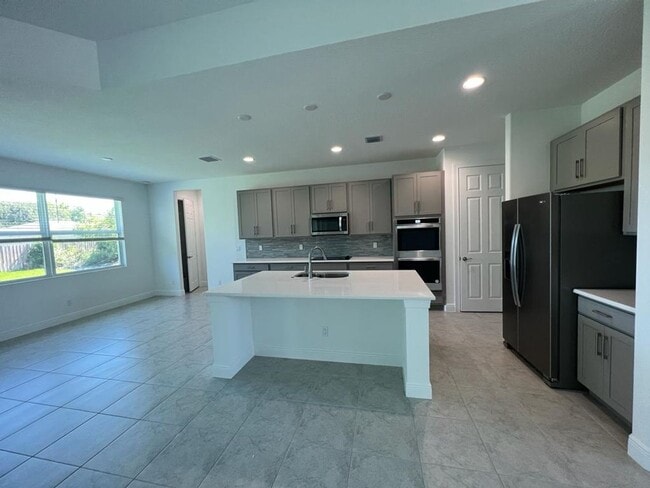 Building Photo - This Charming Brand-New Home is a 4/3 with...