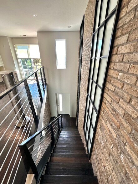 Stairs down to entry way and entry level bedroom with ensuite bathroom - 7870 Civita Blvd