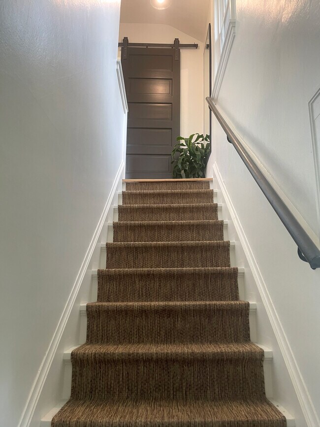 Freshly carpeted stairs lead to upper bedrooms - 3209 Atwood Ave