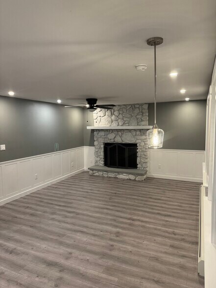 Living area with aesthetic stone fireplace - 25 Maple St