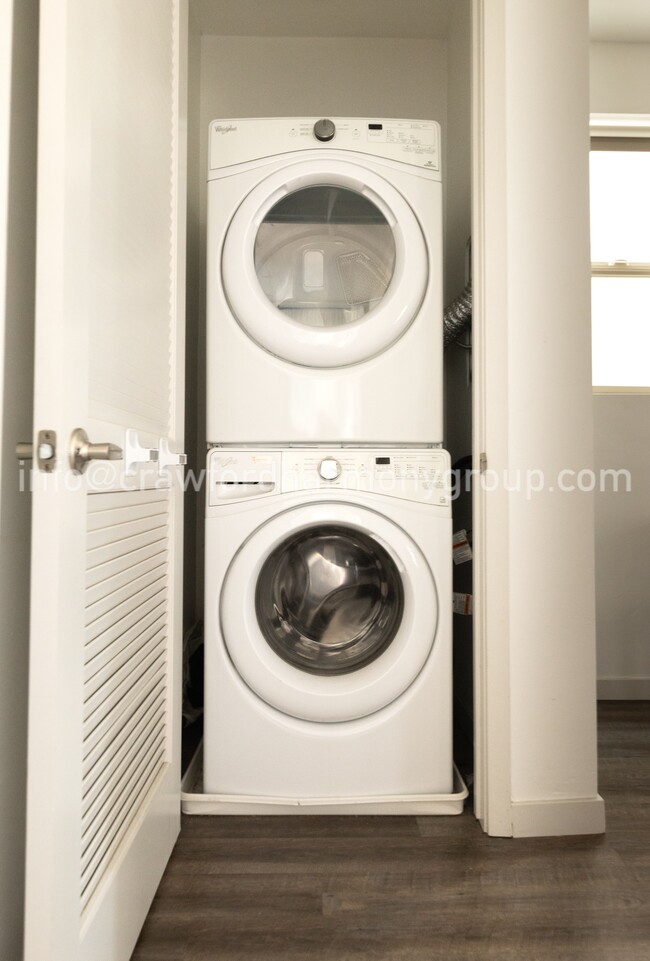 Stacked washer and dryer in closet adjacent to the primary bedroom. - 459 Lug Ln