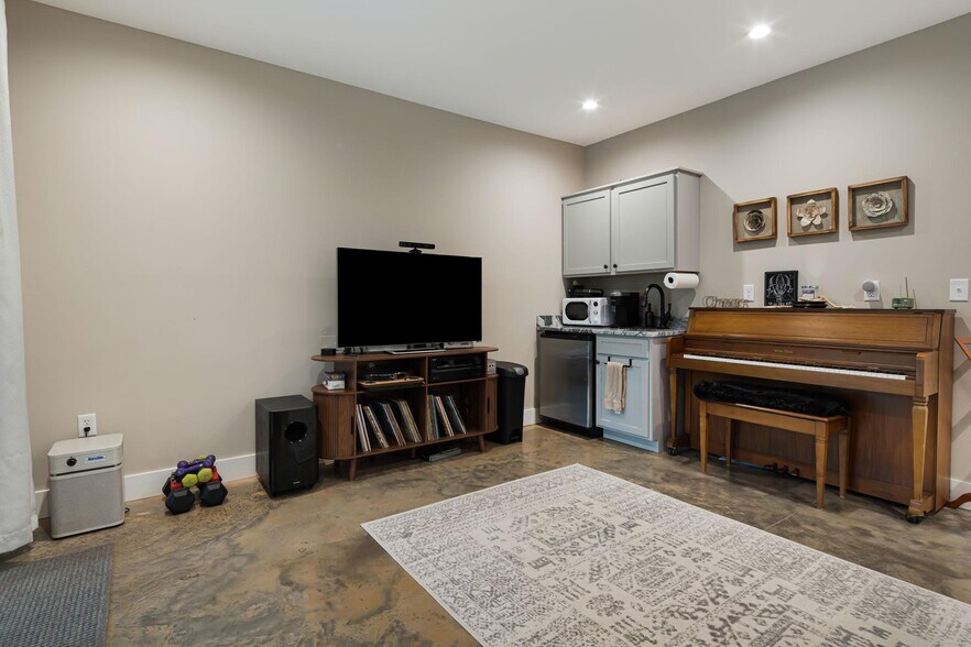 Lower-level kitchenette and entertainment area. - 33 Rex Dr