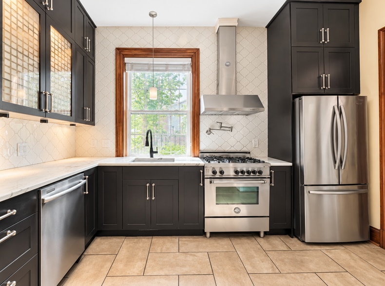 Updated kitchen with stainless appliances, ample cabinetry and gas range - 2322 1st St NW