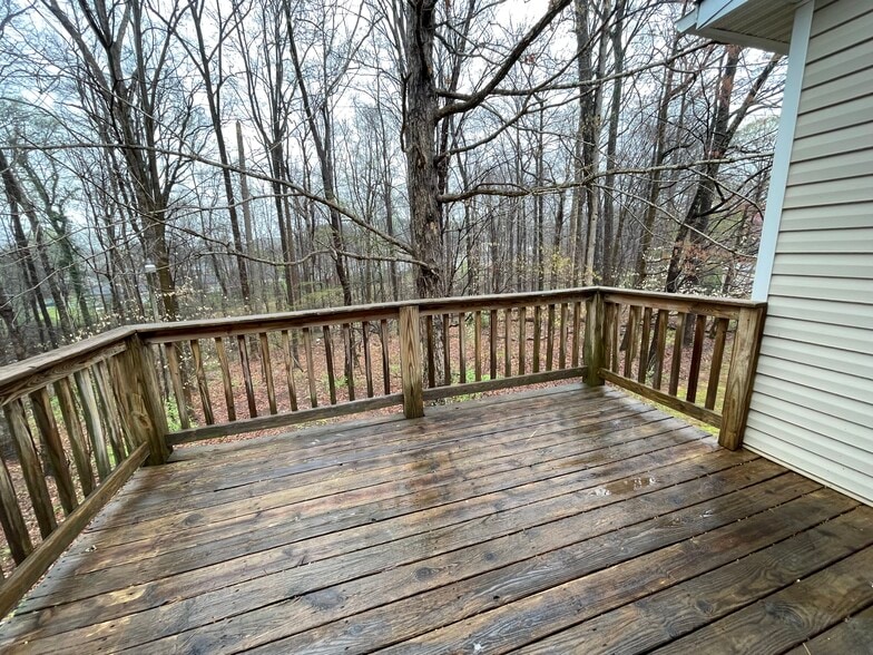 Spacious deck is perfect for gatherings and overlooks a rear natural area - 4684 Coltsfoot Rd
