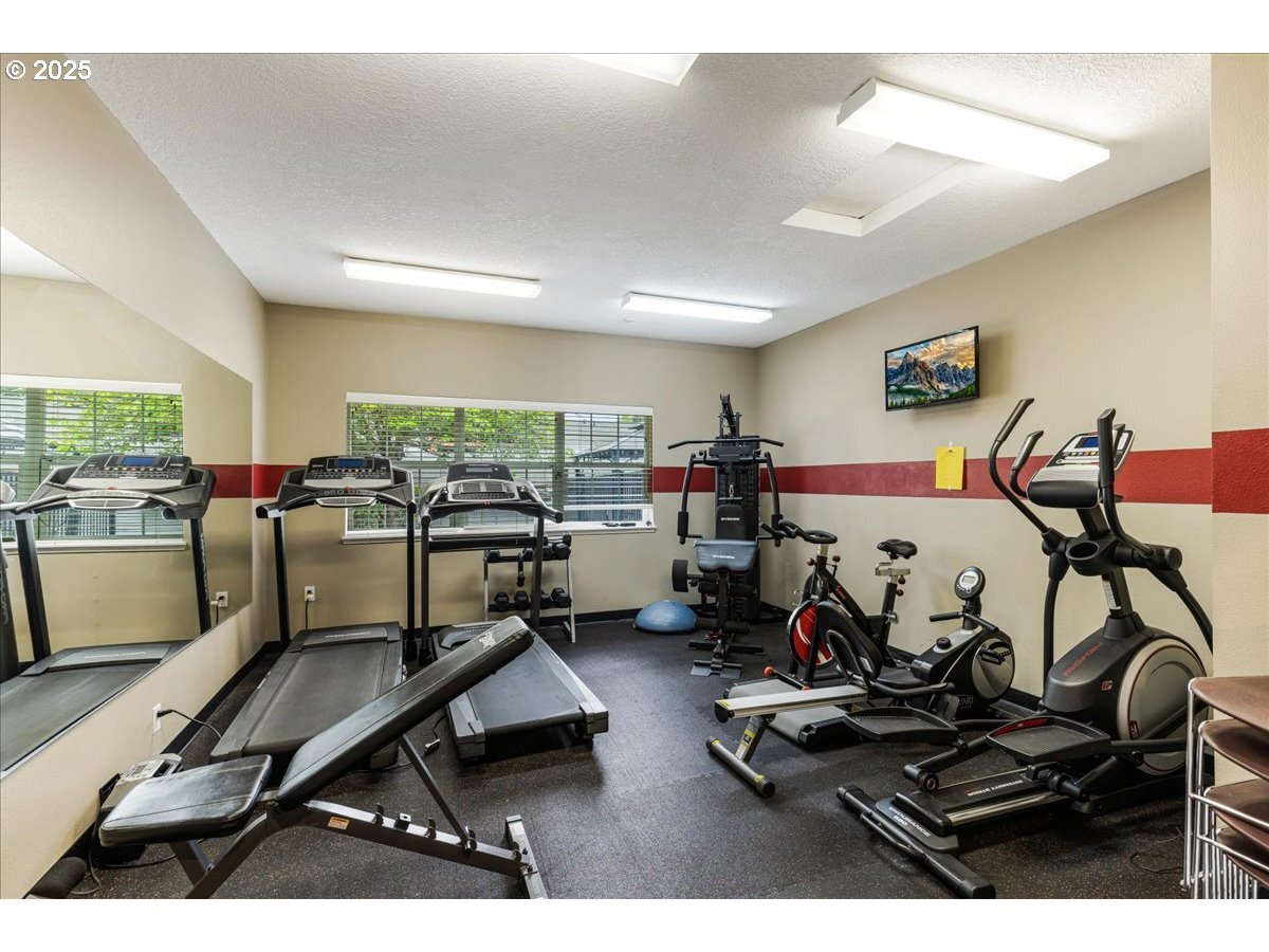Fitness area in clubhouse, including two private showers - 10620 SW Davies Rd
