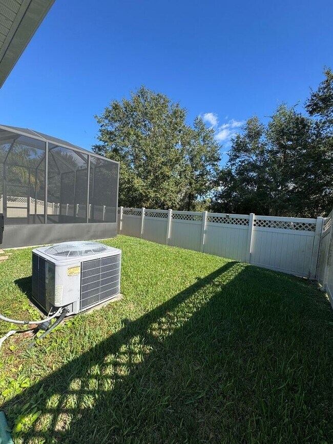 Building Photo - COMING SOON! Beautiful 4BR 3BA Home w/ Screened Lanai & Pond View • Garage Parking • Fenced Yard ...