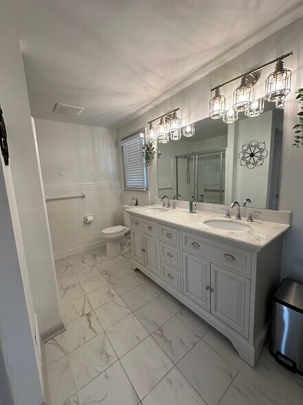 Spacious master bedroom featuring a private bathroom for ultimate convenience and luxury. - 5460 Scofield Rd