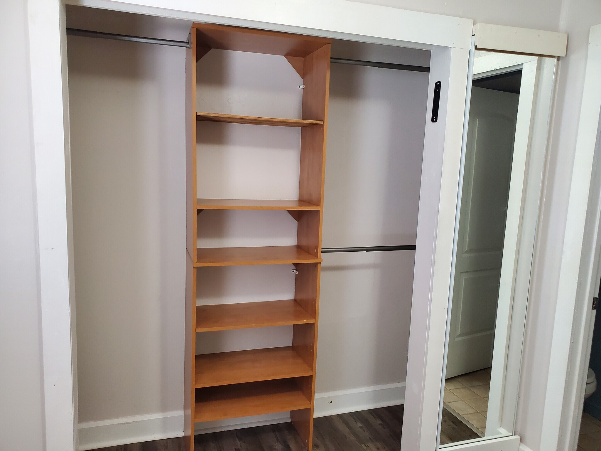Master closet has three hanging rods for closes, shelves and additional storage to the left. - 358 E Lincoln Rd