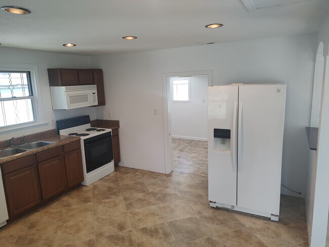 Kitchen leads to third bedroom - 4011 Bandy Rd