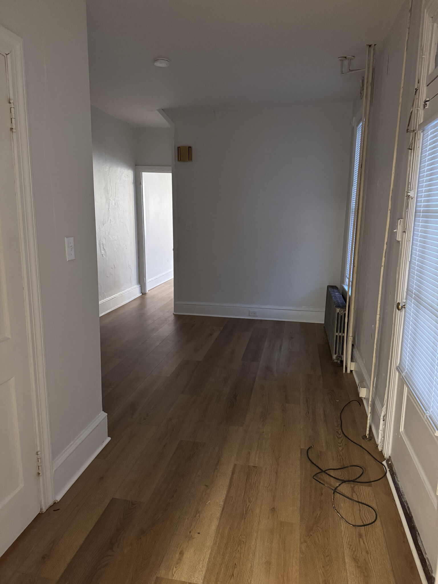 Rear room looking from kitchen. Side door on right. Bathroom on left - 321 Lincoln Way W