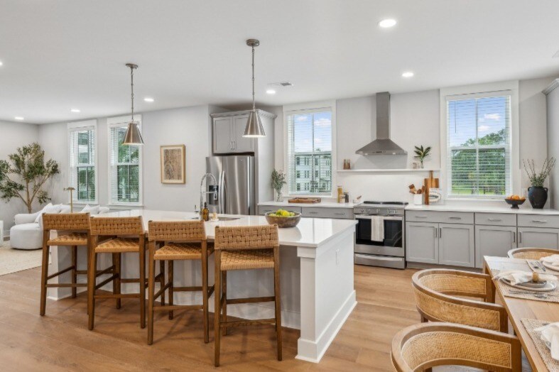 The stylish eat-in kitchen at Fenland Townhomes offers a spacious layout with a large island, high-e - Fenland Townhomes