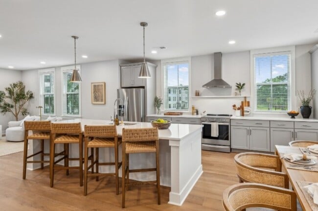 The stylish eat-in kitchen at Fenland Townhomes offers a spacious layout with a large island, high-e - Fenland Townhomes