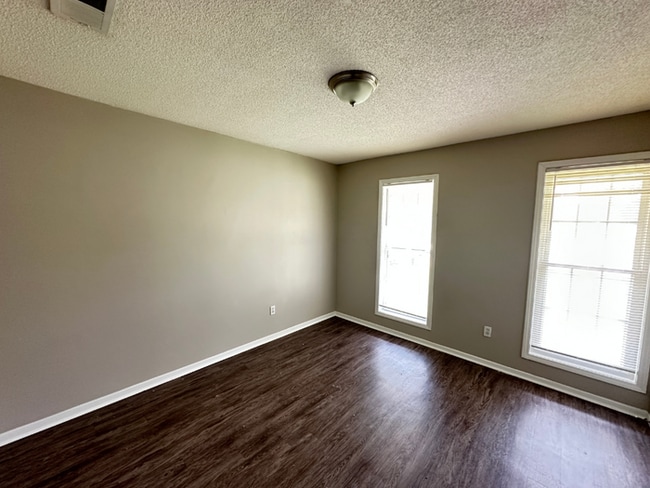 Building Photo - Charming 3BR/2BA Near Southwind | Soaring Vaulted Ceilings, Rustic Fireplace & Garage