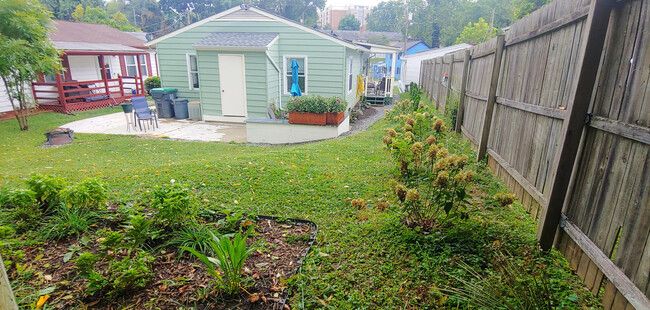 View of back patio and attached shed with built in floor to ceiling storage for tenants - 819 Page St