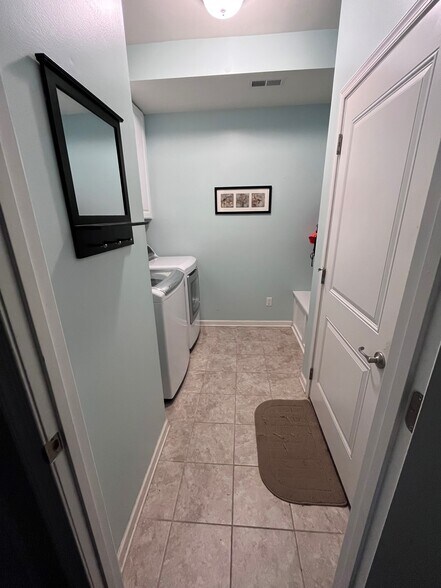 Garage access into the mudroom-laundry room. - 7736 Tranquil Trl